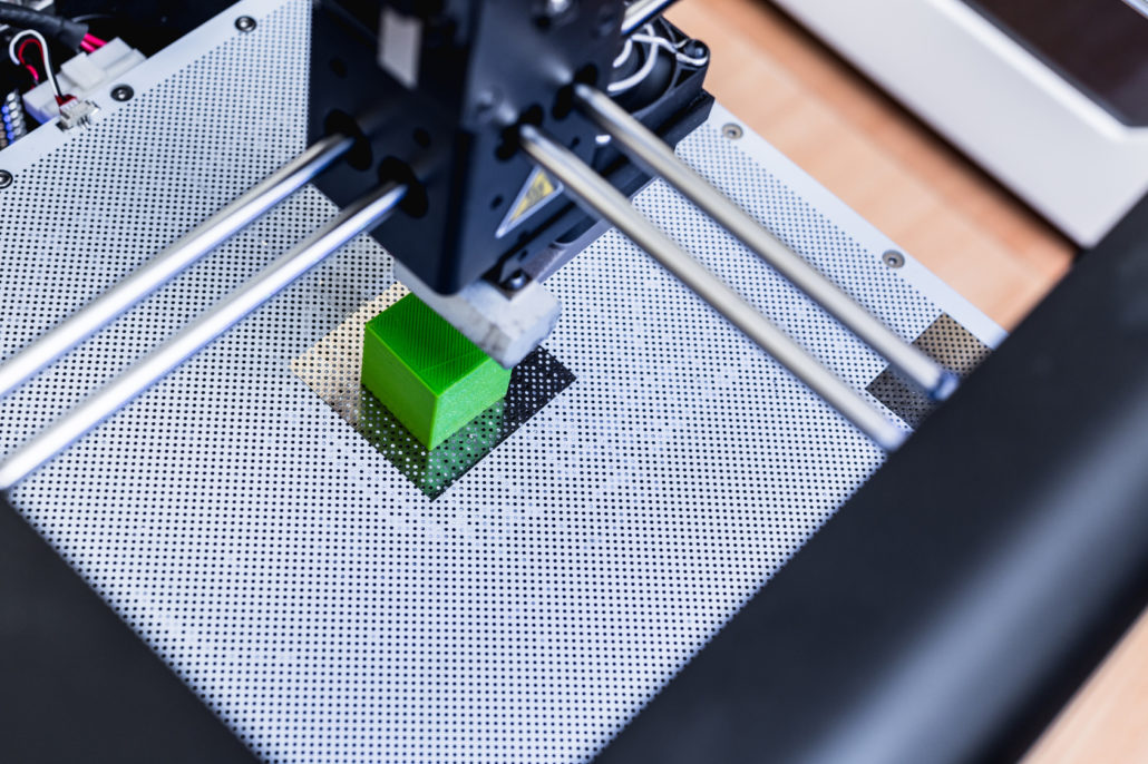 3D Drucker beim 3D Druck eines simplen grünen Würfels